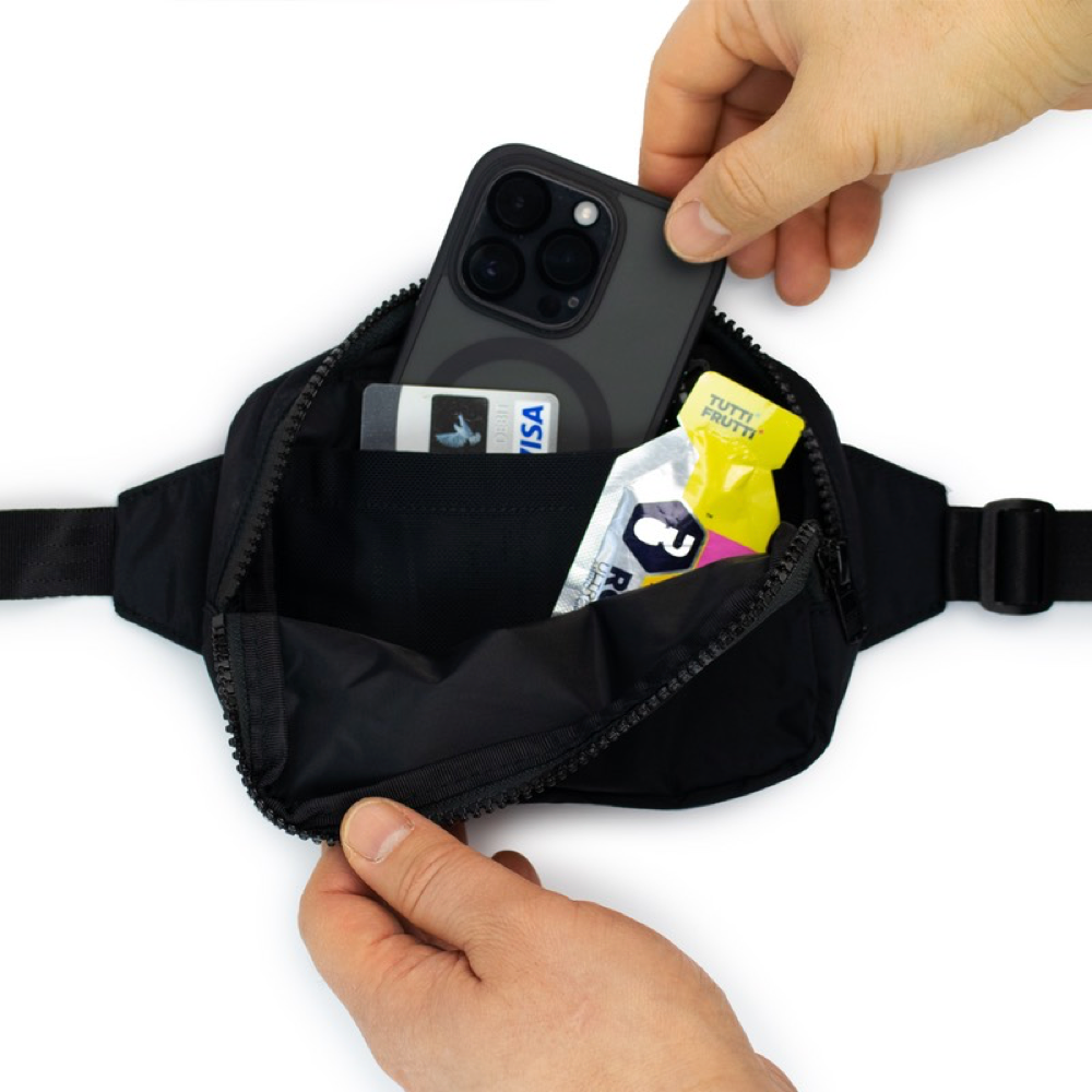 Detail view of Amphipod R3 Express Convertible Pack with example items to store inside.